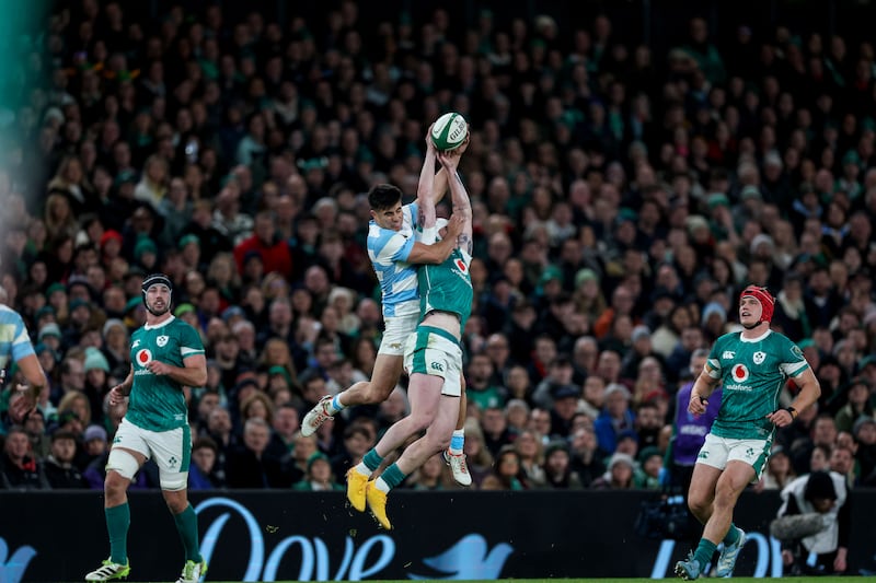 Argentina's Tomas Albornoz and Ireland's Mack Hansen rise high for possession. Photograph: Billy Stickland/Inpho