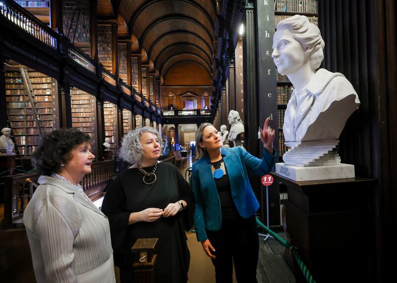 Librarian Helen Shenton, TCD provost Linda Doyle with Catherine Giltrap, curator and head of University Art Collections, uncovers one of four new sculptures of women scholars in Trinity’s Old Library.
Photograph: Chris Bellew/Fennell Photography