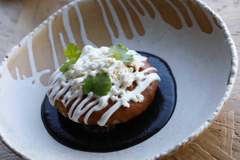 Gordita de chicharrón prensado, black and yellow mole, at Suertudo in Ranelagh. Photograph: Nick Bradshaw