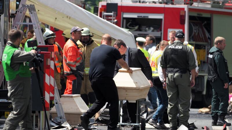 Undertakers bring coffins to the site of  the bus crash on the A9 highway near Muenchberg, southern Germany. Photograph: Nicolas Armer /AFP/Getty Images