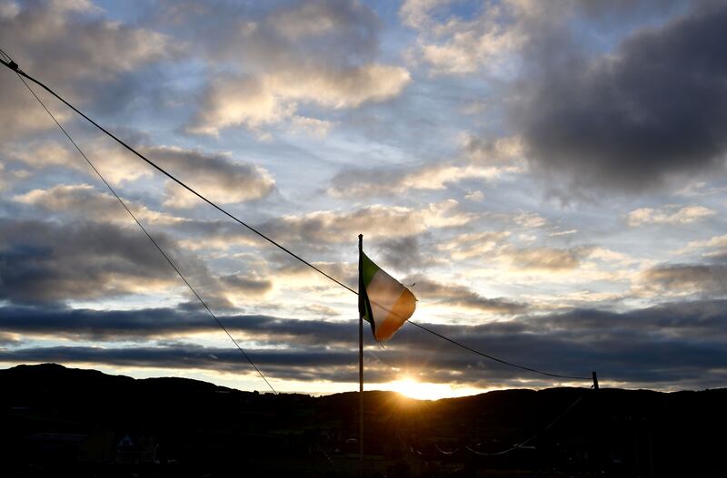 The Irish Tricolour flutters in Newry as the sun rises along the Border between Northern Ireland and the Republic. Photograph: Charles McQuillan/Getty Images