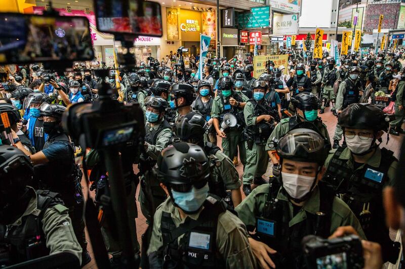 Riot police clear a Hong Kong street as protesters gather to rally against the National Security Law introduced by Beijing in 2020. Photograph: Dale de la Rey/AFP via Getty Images