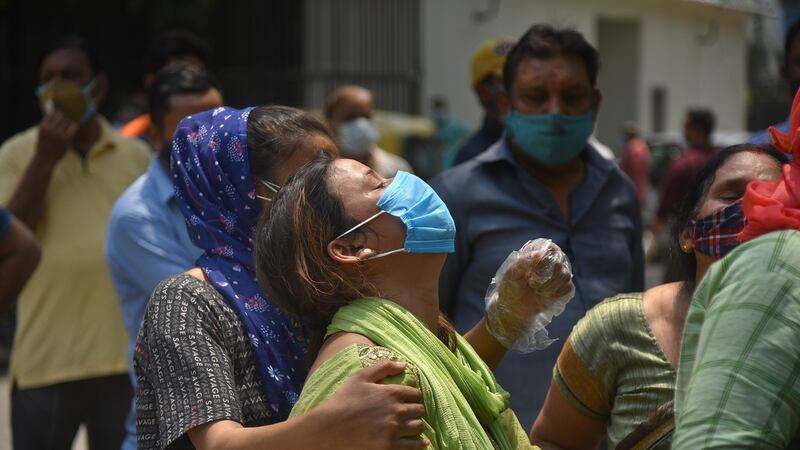 Family members of Covid-19 victims outside a hospital mortuary in New Delhi as deaths continue to spiral. Photograph: Idrees Mohammed