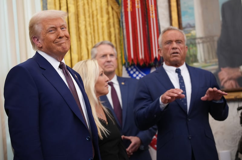 US president Donald Trump smiles as Robert F Kennedy jnr delivers remarks after being sworn in as health secretary. Photograph: Andrew Harnik/Getty Images