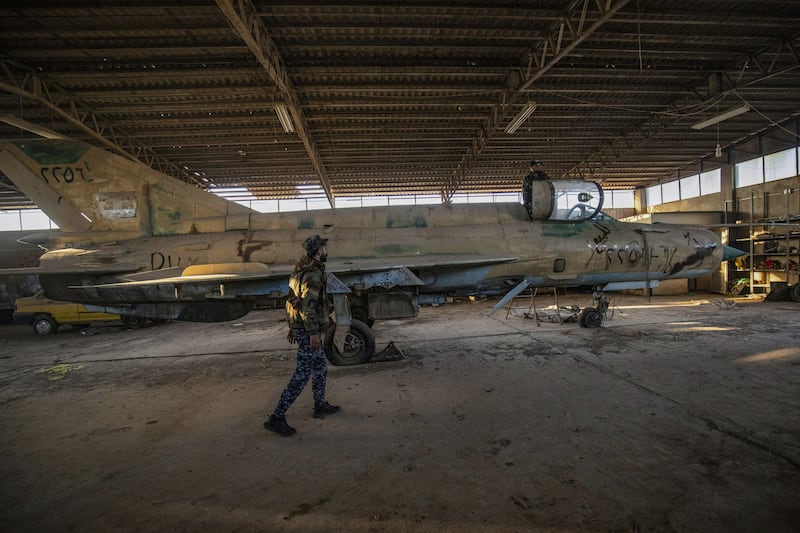 Syrian Democratic Forces fighters inspect an abandoned airplane at the Qamishli airport, formerly a joint Syrian-Russian military base, in northeastern Syria. Photograph: Delil Souleiman/AFP/Getty