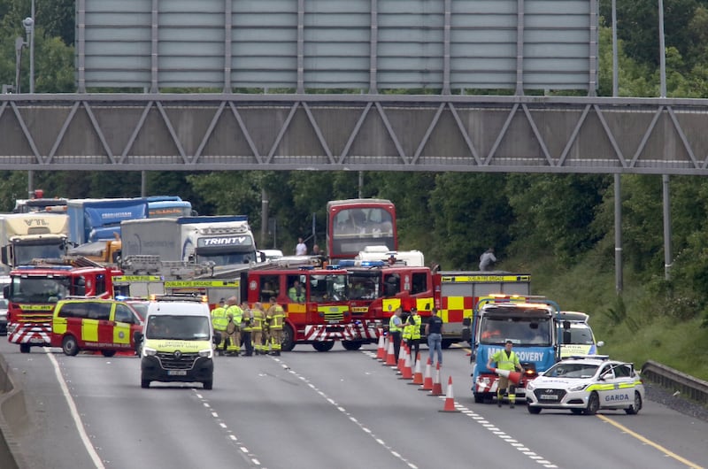 Gardaí at the scene of the collision on the M50 northbound on Friday afternoon which claimed the lives of two motorcyclists. Photograph: Collins