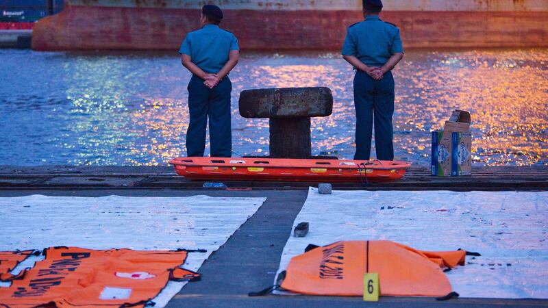 Policemen wait fo help tie up a navy ship bringing further wreckage of Lion Air flight JT 610 at the Tanjung Priok port in Indonesia. Photograph: Getty Images