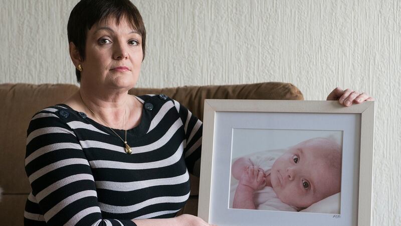 Tina Priestley holding a picture of her son, Bobby, who died at the age of 13 months. Photograph: Dave Meehan/The Irish Times