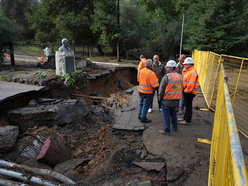 Construction workers take in a road washed away by flooding at the Oakland Zoo in Oakland, California on January 3rd. Photograph: Jim Wilson/The New York Times