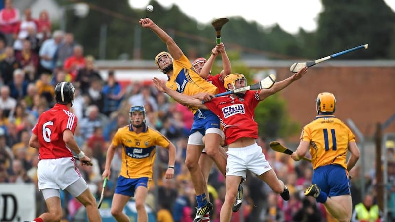 Clare’s Peter Duggan battles to win possession during Wednesday night’s Munster Under-21 hurling final against Cork at Cusack Park, Ennis, Co Clare. Photograph: Sportsfile