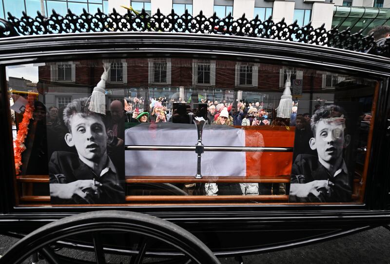 The hearse carrying the remains of Shane MacGowan during the funeral procession in Dublin city centre. Photograph: Charles McQuillan/Getty