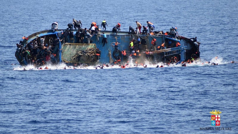 This image released yesterday by the Italian navy shows the sinking of a boat of migrants off the Libyan coast. At least five migrants drowned after the heavily overcrowded fishing boat they were sailing on overturned, the Italian navy said Photograph: Italian Navy (Marina Militare)/AFP/Getty Images