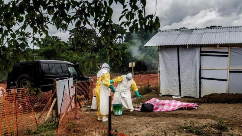 Health workers in protective suits transfer the body of an Ebola victim to the morgue at the MSF Ebola treatment center in Kailahun, Sierra Leone. Photograph: Tommy Trenchard/The New York Times