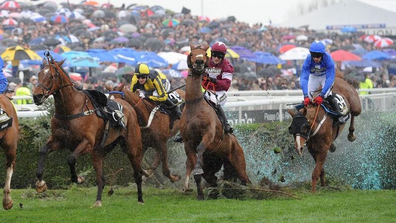 Brian O’Connell riding Quito De La Roque (C ) clears the Water Jump on the first lap of the tack. Photograph: EPA