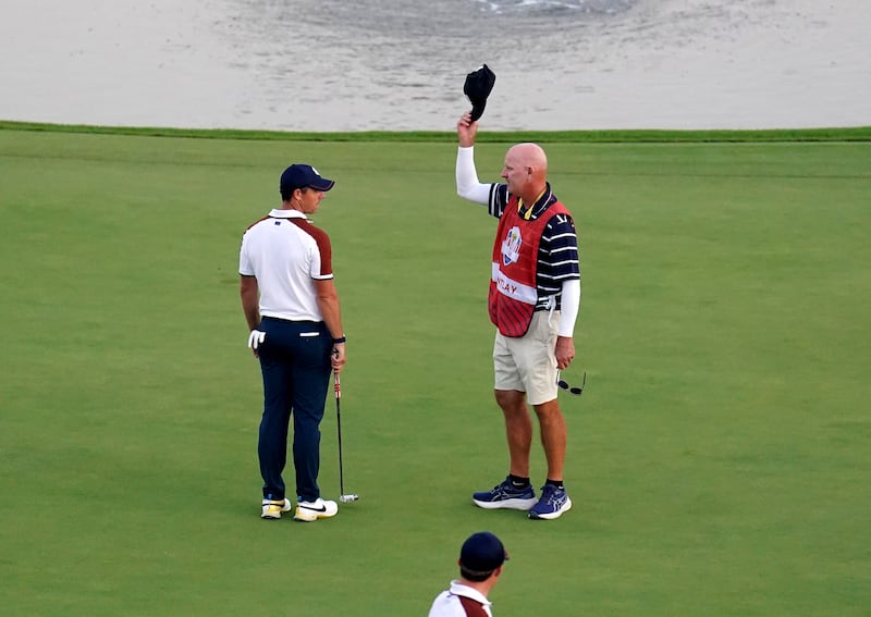 Rory McIlroy argues with Joe LaCava, caddie of USA's Patrick Cantlay on the 18th. Photograph: PA