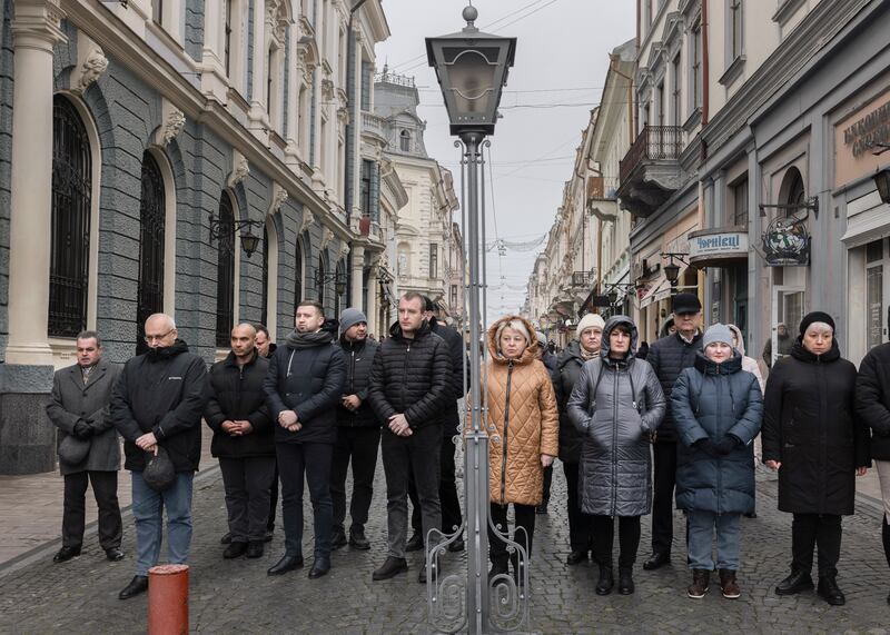 Residents and city workers in the central square of Chernivtsi, Ukraine observe a moment of silence to honor those killed in the war, on November 23rd. Photograph: Emile Ducke/The New York Times