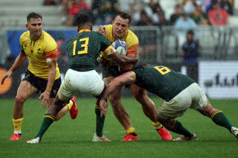 Romania centre Taylor Gontineac is tackled by South Africa's Canan Moodie and flanker Marco van Staden during the Rugby World Cup Pool B match at Stade de Bordeaux. Photograph: Romain Perrocheau/AFP via Getty Images