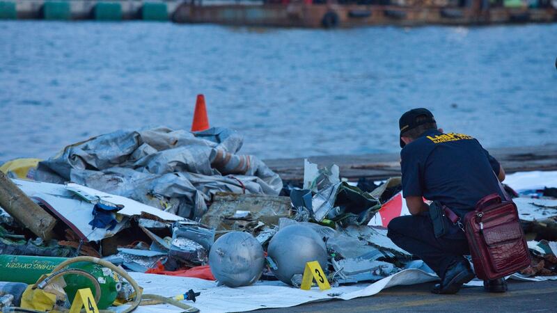 A forensic investigator looks through the remains of Lion Air flight JT 610 at the Tanjung Priok port. Photograph: Getty Images