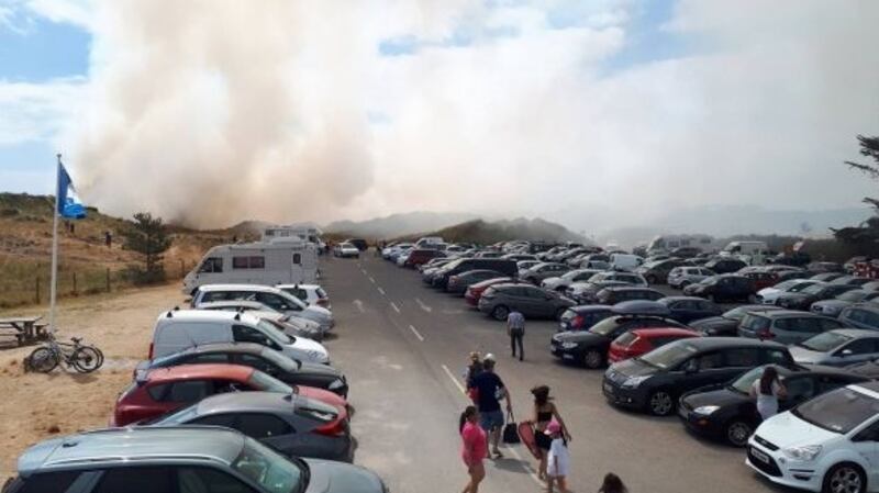 Hundreds of people were evacuated from Curracloe beach in Co Wexford on Sunday after a fire broke out in the sand dunes. Photograph: Surf Shack Curracloe/Facebook