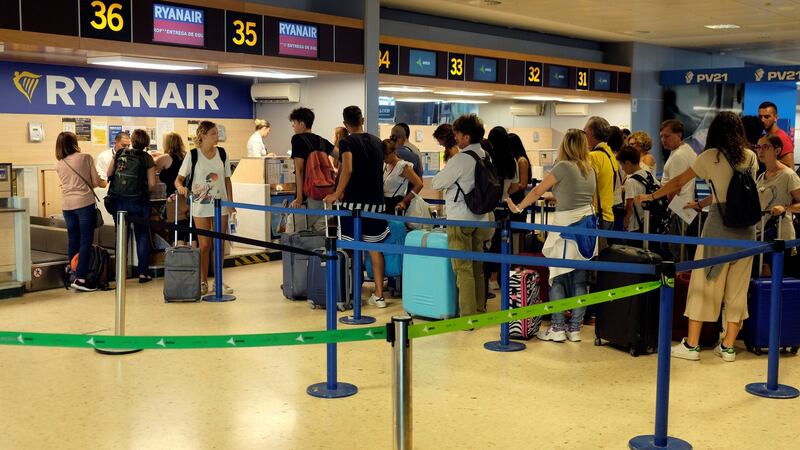 Ryanair passengers line up to check in their luggage. Photograph: Heino Kalis/Reuters