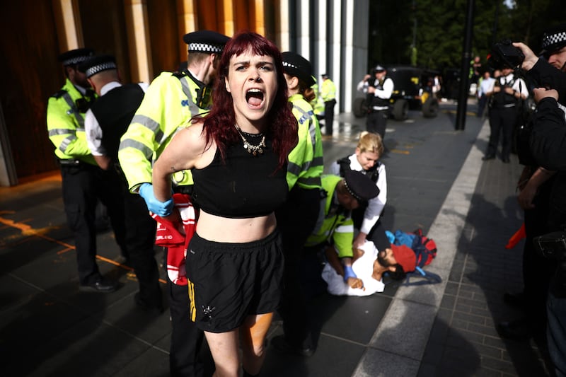 A Just Stop Oil activist is detained in the Canary Wharf district in London on Tuesday. Photograph: Henry Nicholls/AFP via Getty Images