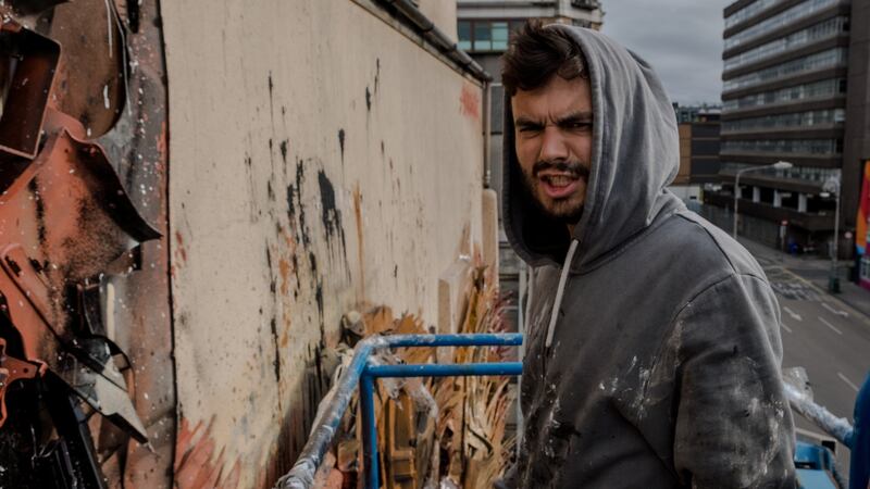 The Portuguese artist Artur Bordalo working on his Dublin piece on Tara Street