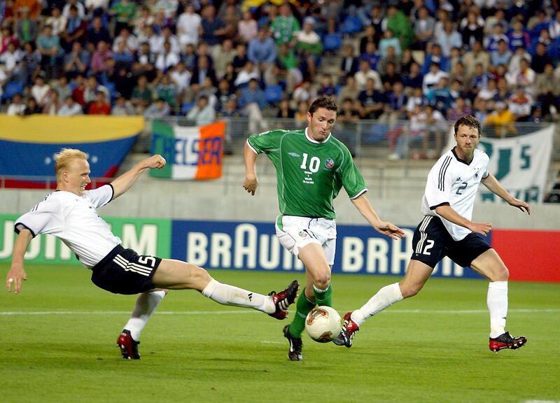 Robbie Keane of Ireland takes the ball past Carsten Ramelow and Thomas Linke of Germany to score in the 2002 World Cup. Photograph: Andrew Paton/Inpho