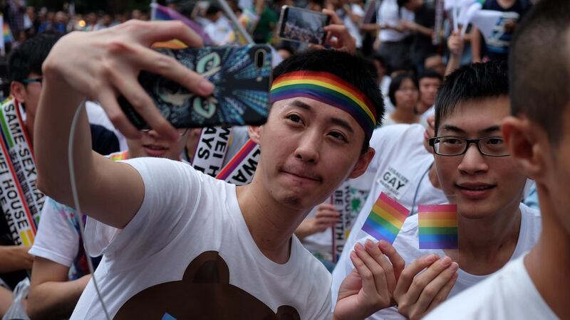 Supporters of LGBT rights celebrate the landmark decision paving the way for Taiwan to become the first place in Asia to legalise same-sex marriage, in Taipei on Wednesday. Photograph: Sam Yeh/AFP/Getty Images