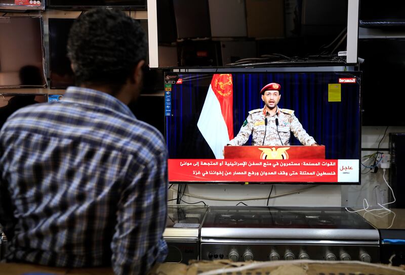 A viewer in Sana'a, Yemen, watches a TV statement by the Houthis' military spokesman Yahya Sarea following a missile and drone attack by Yemen's Houthis targeting Red Sea shipping lanes. Photograph: Yahya Arhab/EPA