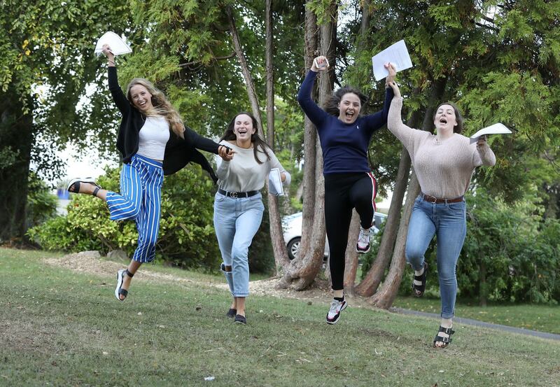 JUMP AND JIVE: Holly Vambeck of Wicklow Town (left); Anna Kavanagh, Enniscorthy, Co Wexford; Eimear O'Neill, Clonmellon, Co Meath, and AnnaBlaine, Killala, Co Mayo, celebrate their results at Rathdown School, Glenageary, Co Dublin. Photograph: Justin Mac Innes/Jason Clarke Photography