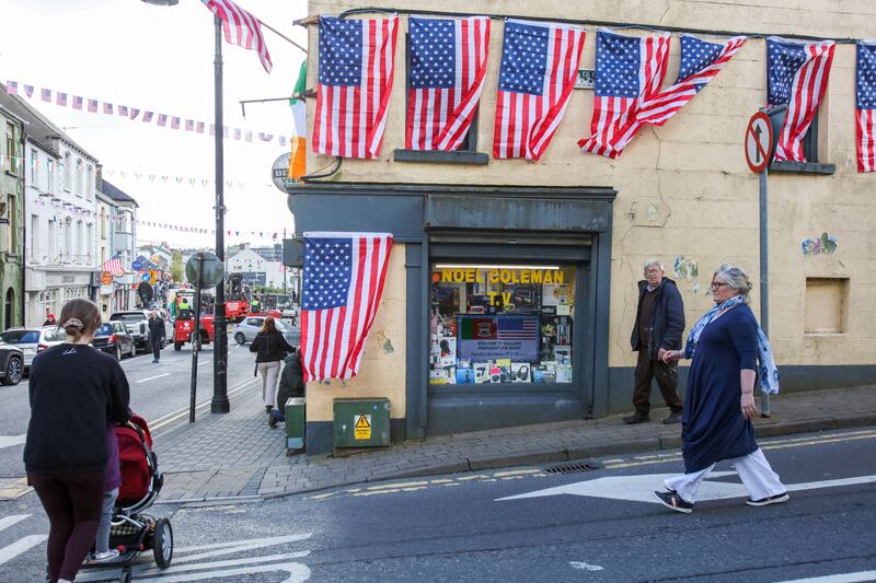 Pedestrians pass a shop adorned with US flags in Ballina on Friday. Photograph: Paul Faith/AFP via Getty