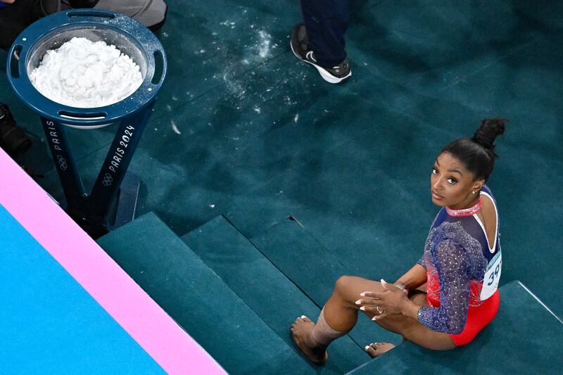 Simone Biles preparing to compete in the artistic gymnastics women's floor exercise final at the Bercy Arena in Paris, on August 5, 2024. (Photo by ODD ANDERSEN/AFP via Getty Images)