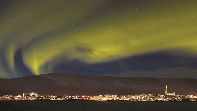 Reykjavik with the Northern Lights overhead