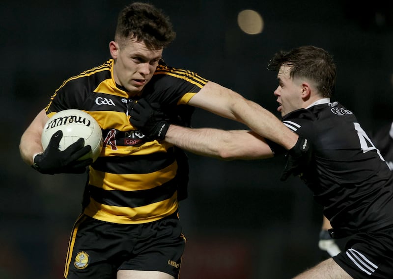 Crosserlough’s Dara McVeety is tackled by Callum Rogers of Kilkoo. Photograph: Ben Brady/Inpho