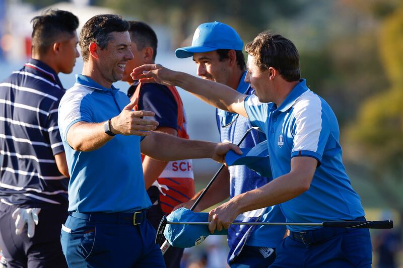 Rory McIlroy and Matt Fitzpatrick celebrate on the 15th green following their fourball victory over Collin Morikawa and Xander Schauffele at Marco Simone Golf Club. Photograph: Mike Ehrmann/Getty Images