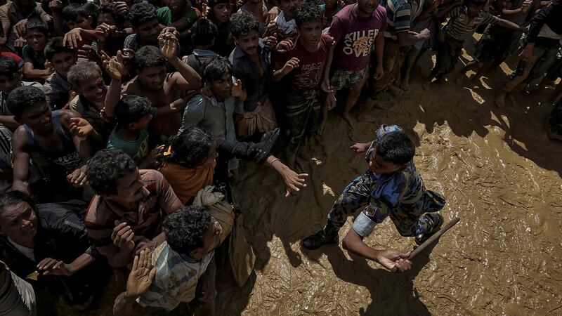 A security officer attempts to control Rohingya refugees waiting to receive aid in Cox’s Bazar, Bangladesh, in 2017. Photograph: Cathal McNaughton/Reuters