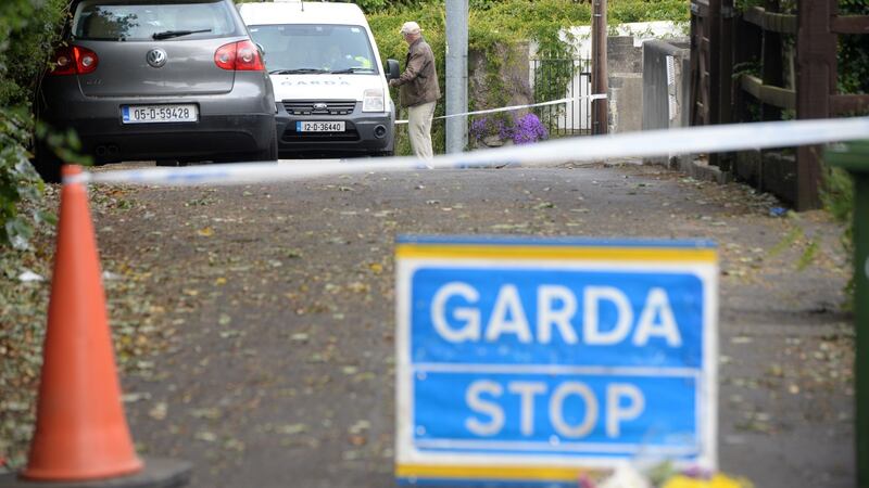 Gardaí  at the cordoned-off scene of a fatal house fire at Lansdowne Valley, Drimnagh, Dublin. Photograph: Dara Mac Dónaill