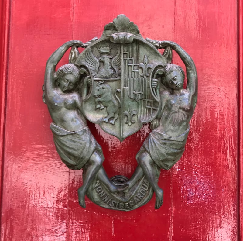 Ornate knockers adorn the palazzo doors in Mdina