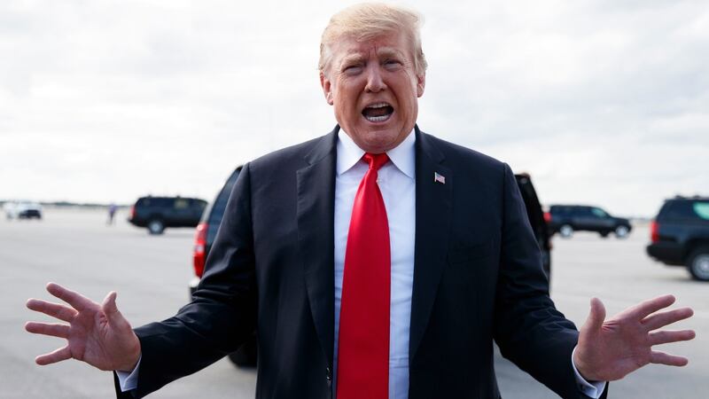 Donald Trump speaks to media before boarding Air Force One,  at Palm Beach International Airport, Florida. Photograph: AP Photo/Carolyn Kaster