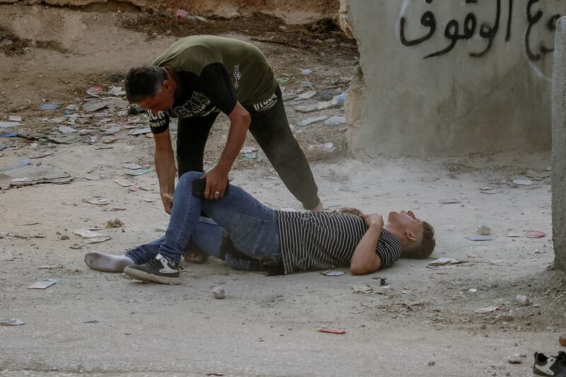 Alaa Ashraf Adili, a civilian, is hit by gunfire from Israeli forces in the village of Osarin in the northern West Bank. Photograph: Wahaj Beni Moufleh/ AFP via Getty Images