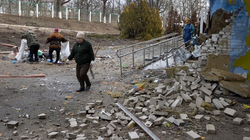 Residents clean up debris at the hospital in Trostyanets. The  hospital was refurbished last autumn and was damaged at the end of March. Photograph: Tyler Hicks/New York Times