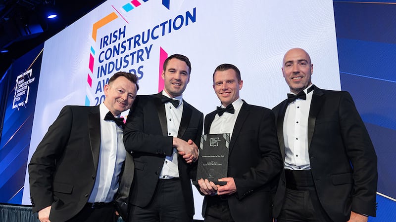 Shane Lannon, managing consultant at Lumen Search, presents the contractor project of the year award to the McAleer & Rushe team