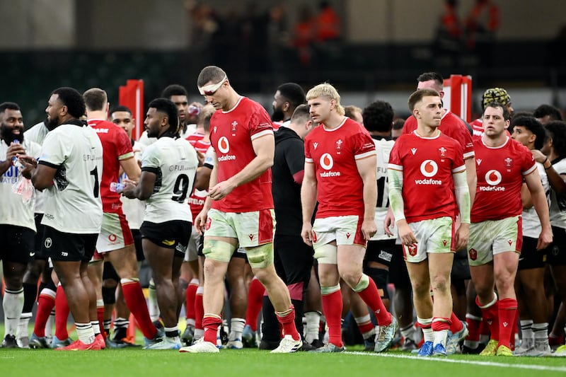 Will Rowlands and Aaron Wainwright of Wales look dejected after walking through a guard of honour formed by players of Fiji, following defeat to Fiji. Photograph: Dan Mullan/Getty