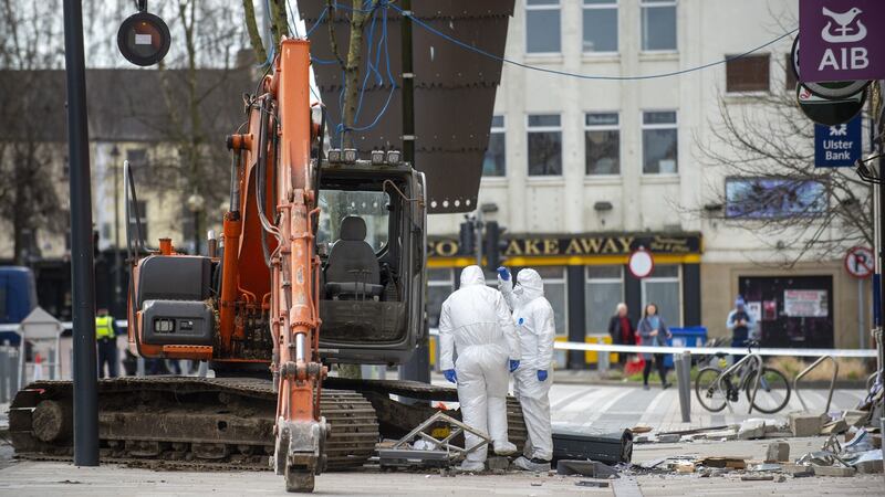 Forensic gardaí are seen examining the scene. Photograph: Ciara Wilkinson