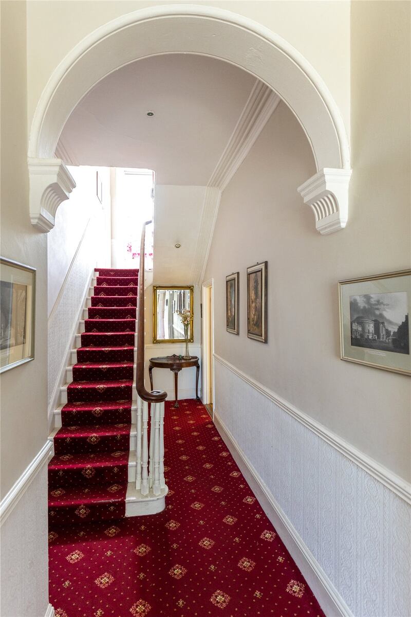 The large entrance hall and two reception rooms either side of it have all their original period features and the deep bay windows 