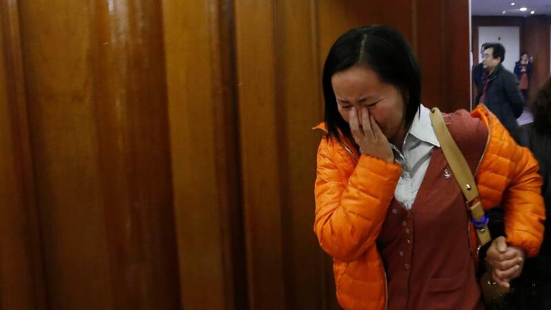 A woman cries as she walks out of a room for relatives or friends of passengers aboard the missing Malaysia Airlines flight MH370 at a hotel in Beijing. Photograph: Reuters/ Kim Kyung-Hoon