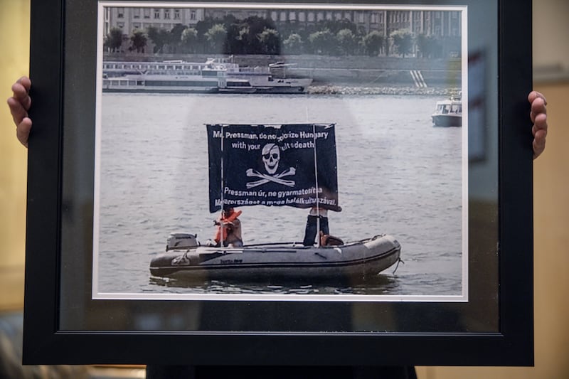 A framed photo that David Pressman hangs above his desk in his embassy office. It shows a dinghy with an anti-gay message that appeared on the Danube near the US Embassy at the same time as his confirmation hearing began in Washington. The banner reads: “Mr. Pressman, don’t terrorize Hungary with your cult of death.” Photograph: Akos Stiller/The New York Times