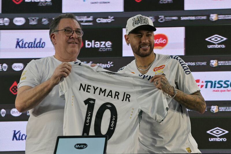 Neymar with the president of Santos, Marcelo Pirilo Teixeira, in Sao Paulo after he returned and signed a six-month deal with his boyhood club. Photograph: Nelson Almeida/AFP 