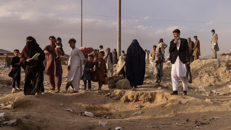 People  gather in a field outside the military side of Hamid Karzai International Airport in Kabul on  August 23rd. Photograph: Victor J Blue/New York Times