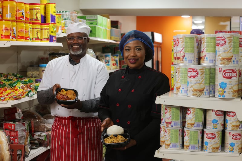 Arinze and Nnenna Onuorah holding rice and plantain with assorted meats as well as egusi soup with pounded yam. Photograph: Alan Betson

